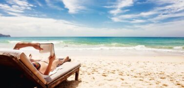 Woman reading a book on a beach