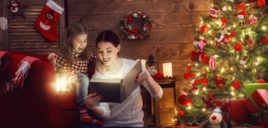 A woman reading to a child a book at Christmas