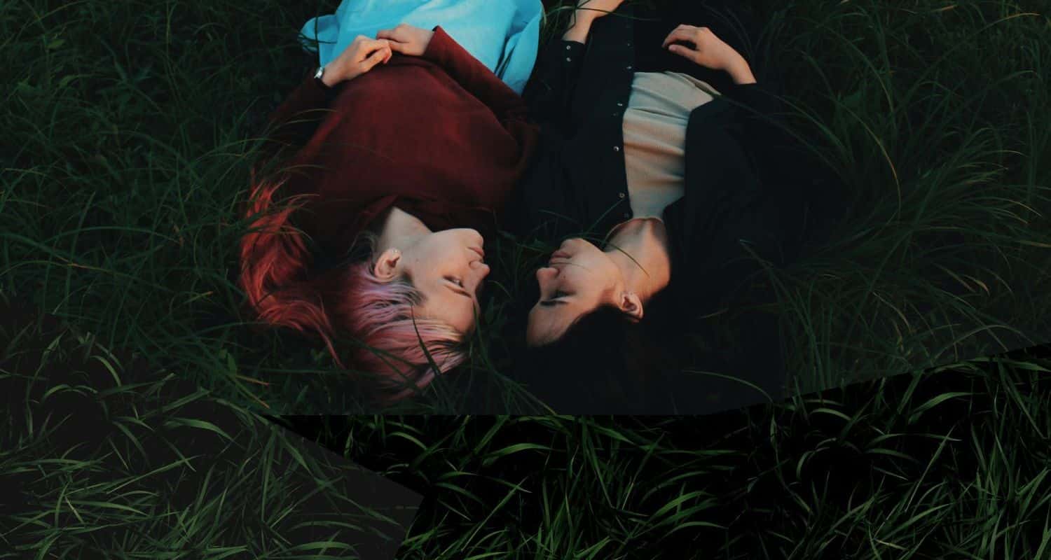 Lesbian couple lying on the grass