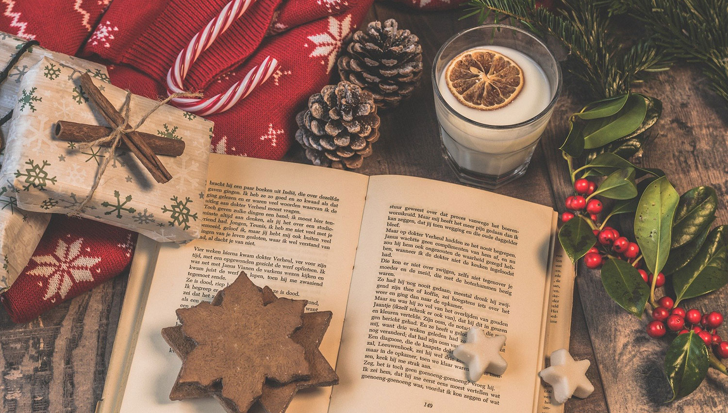A book with a spicy latte by the Christmas tree